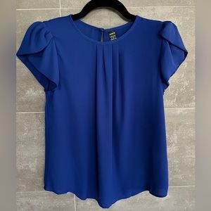 Blue top with petal sleeve.